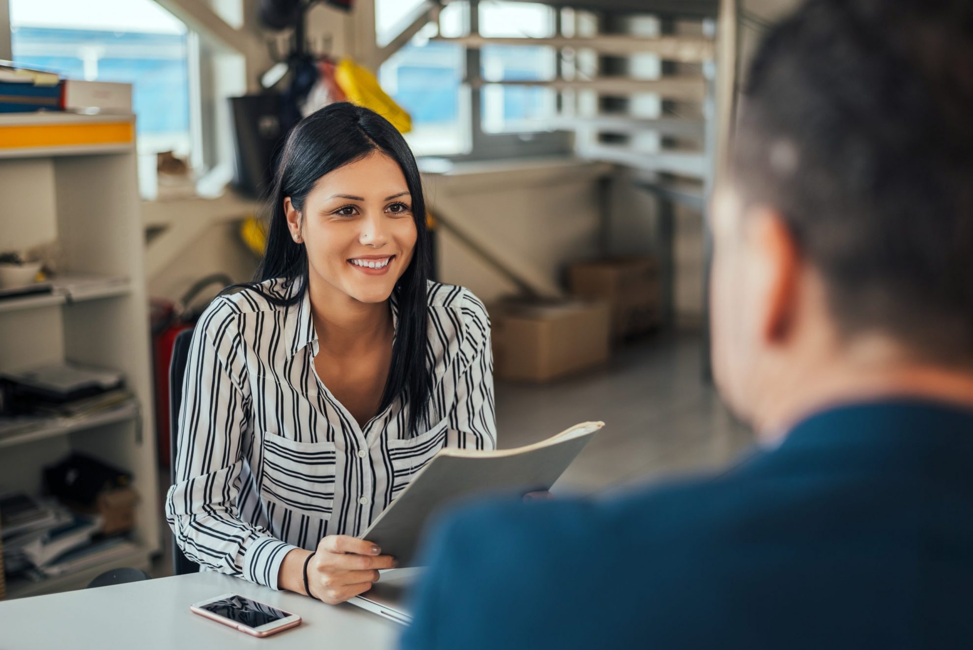 Woman consultant talking with client in office.