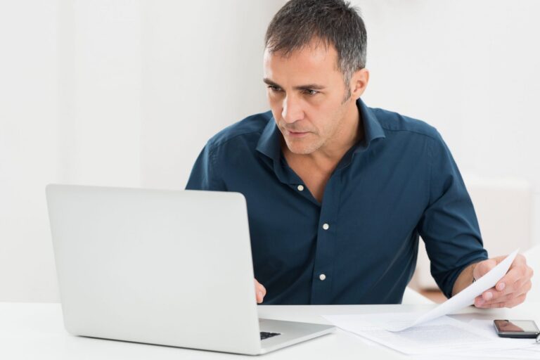 Image of man in front of computer illustrates blog: "How to deal with your inner critic"
