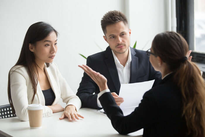 Photo of two women and one man talking illustrates blog: "Handling Negative Feedback: 3 Tips for Leaders"