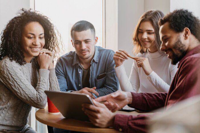 Photo of team meeting illustrates blog: "How to Make Team Meetings More Engaging"