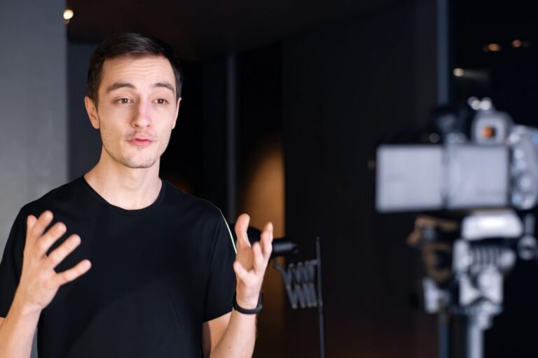 Man talking in front of camera illustrates blog "What Is Content Marketing?"