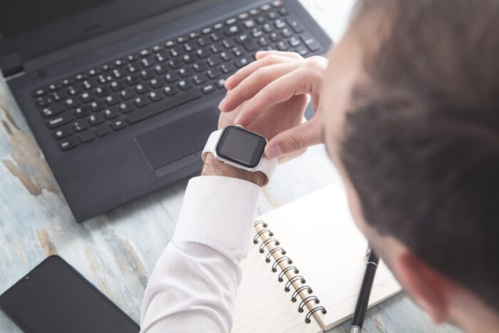 Man looking at his watch illustrates blog "5 Time Management Tips for Small Business Owners"