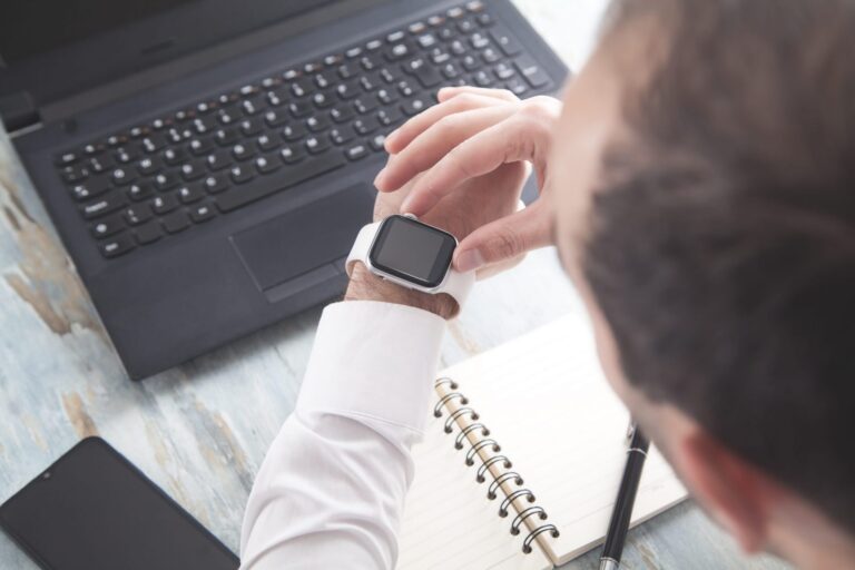 Man looking at his watch illustrates blog "5 Time Management Tips for Small Business Owners"