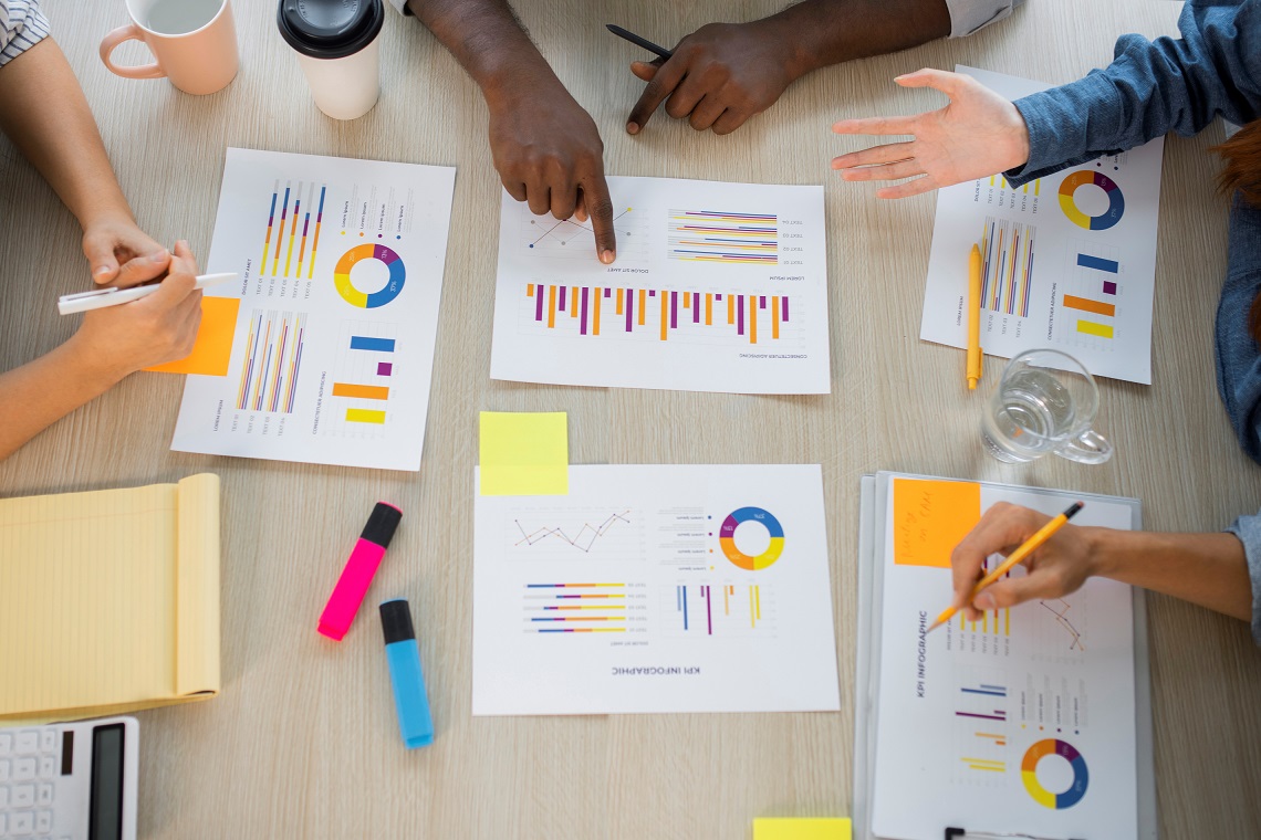 strategy-FP Photo of people at table pointing at graphics/