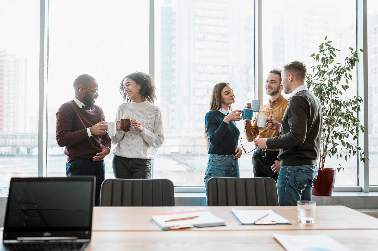 Group of five people networking in office