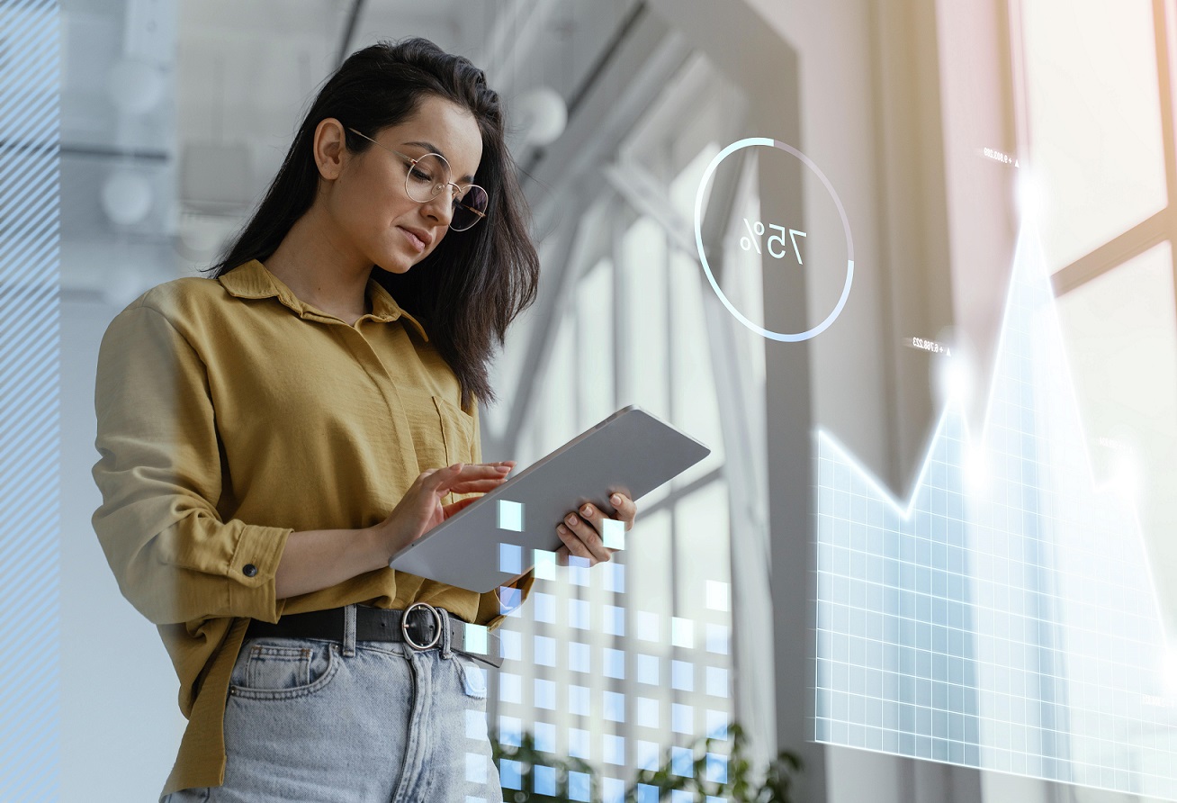 innovation-fp Woman holding tablet with futuristic hologram in front of her illustrates blog "Here’s How Businesses Can Foster Innovation"