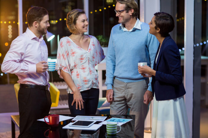 business-people-interacting-with-each-other-office Small business hosting a community pop-up event to engage local customers