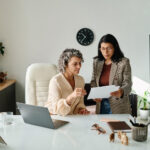 entrepreneur reviewing business insurance basics with advisor in office