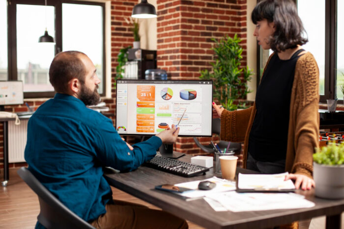 Small business owner using business decision data to review sales and customer trends