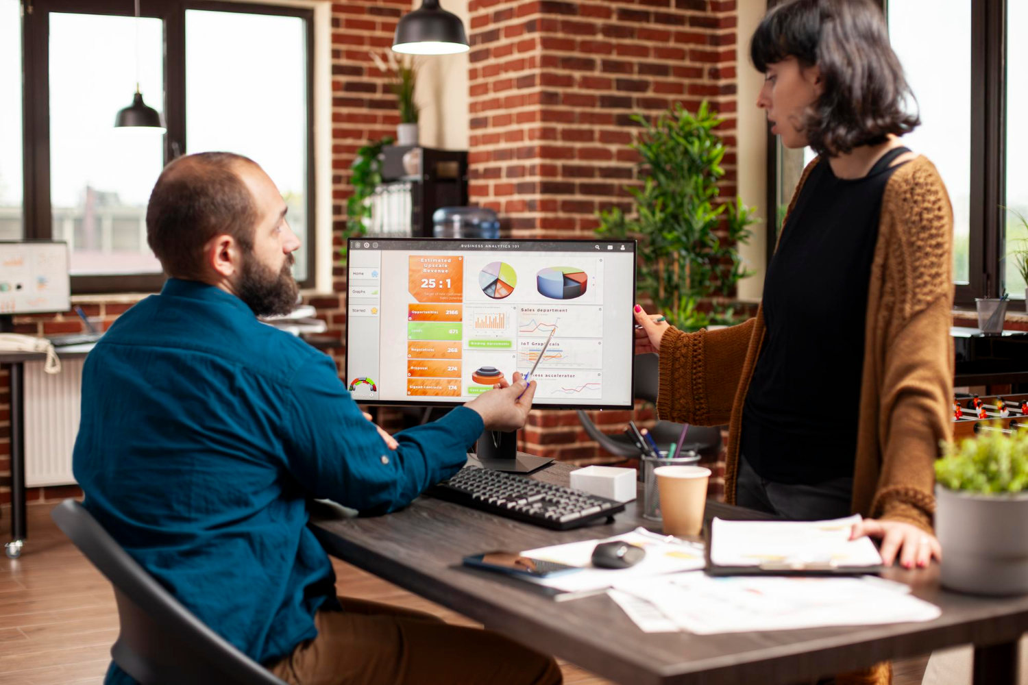 Small business owner using business decision data to review sales and customer trends
