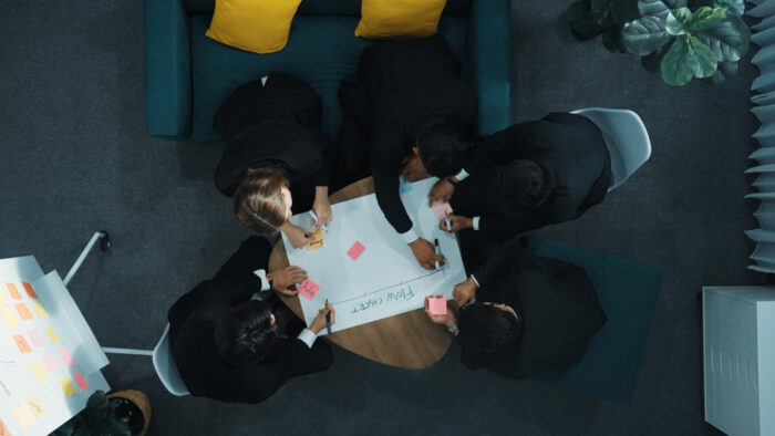 Professionals reviewing collaboration beats competition local strategy and planning documents