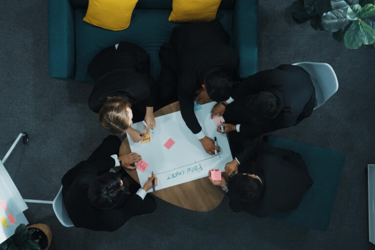 Professionals reviewing collaboration beats competition local strategy and planning documents