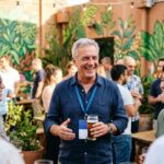 First-time entrepreneur using a business networking guide at a Pomona event